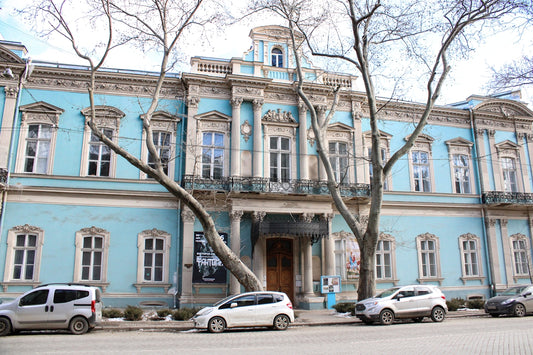a blue building with many cars parked in front of it