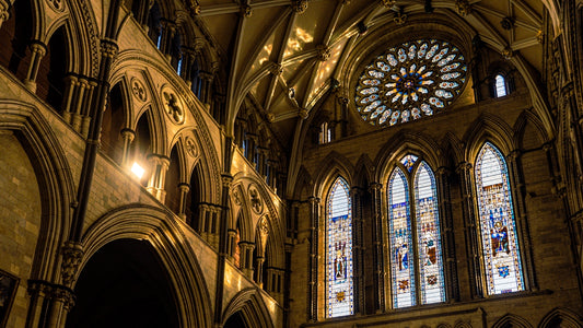 a large cathedral with stained glass windows and a clock