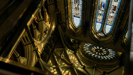 looking up at a stained glass window in a cathedral