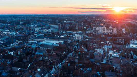 the sun is setting over a large city