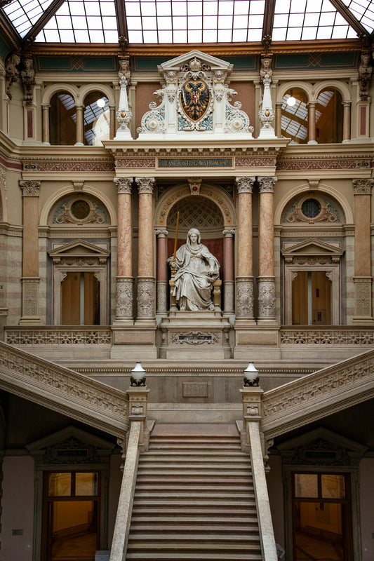 a large building with a staircase and a statue on the wall