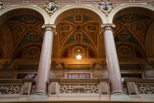 an ornate building with columns and a light