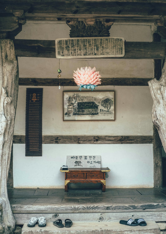 An asian building's interior with decor and shoes.