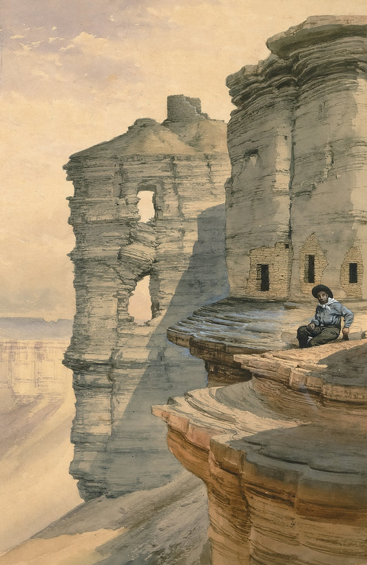 Man sitting on cliff edge overlooking canyon