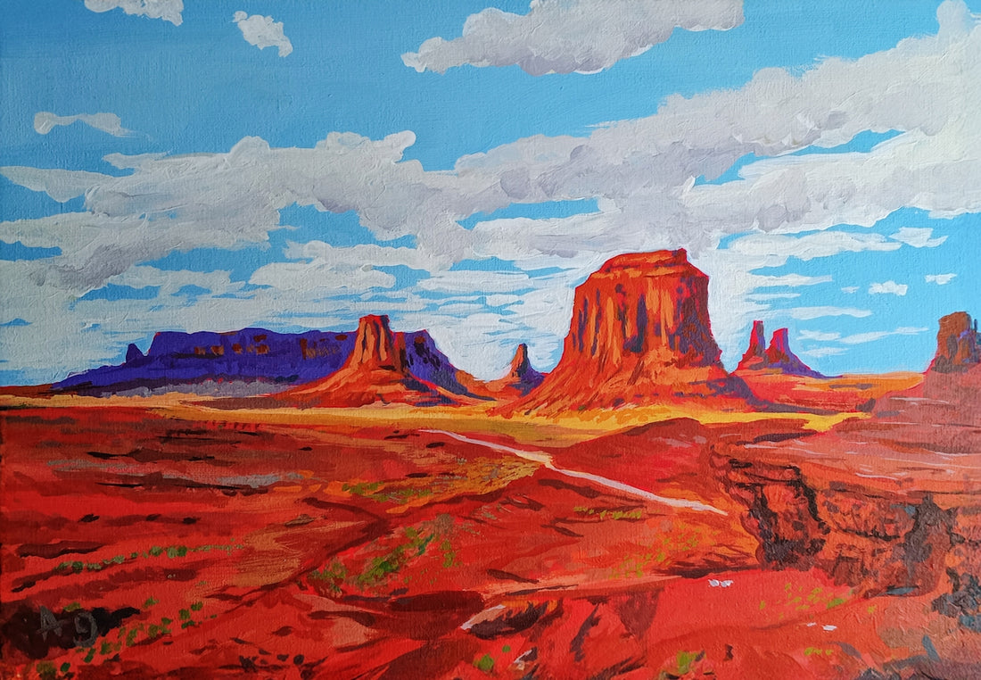 Red rock formations under a blue sky with clouds
