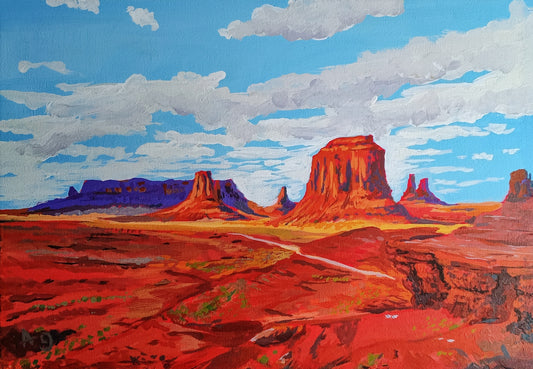Red rock formations under a blue sky with clouds