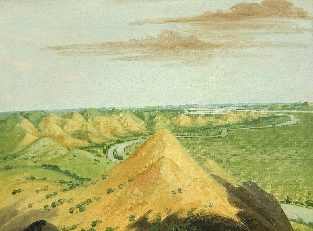 Rolling hills with a winding river under a cloudy sky