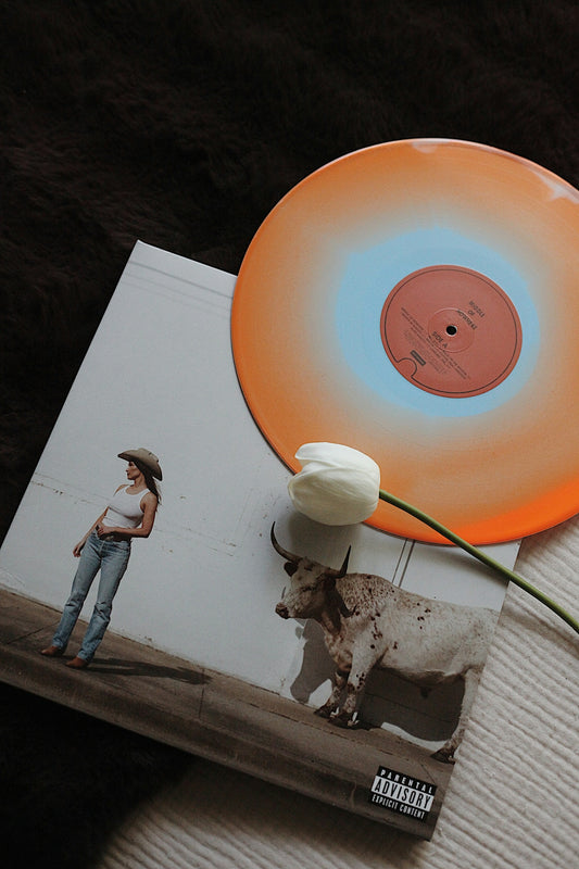 Vinyl record with a tulip and album art.